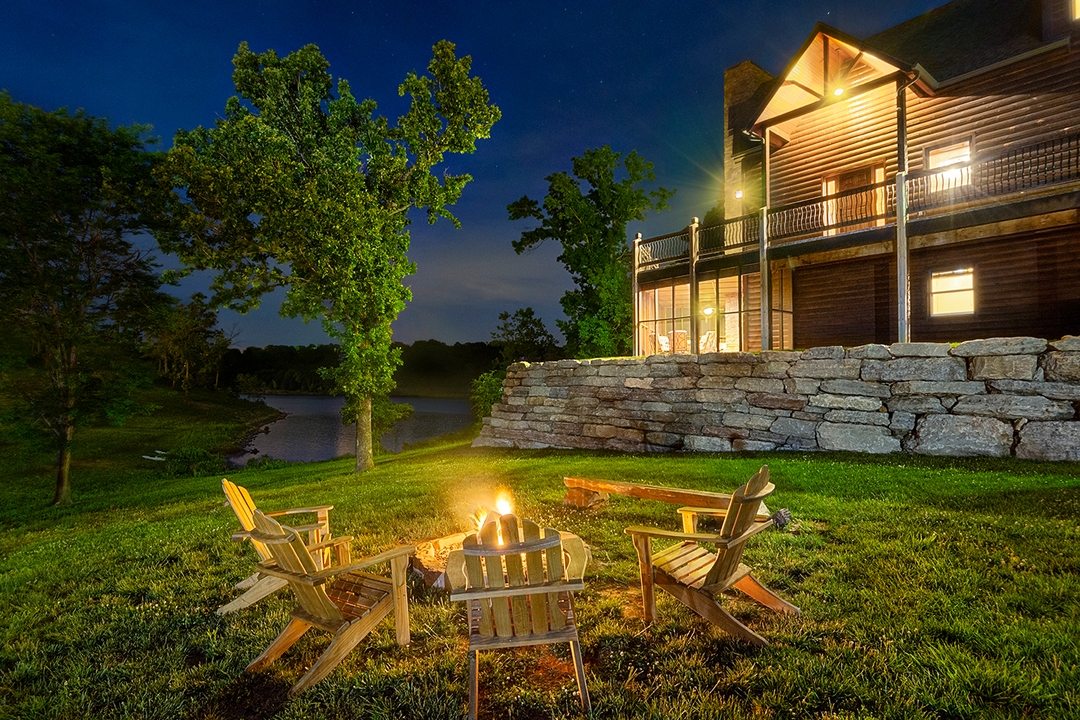 A lakefront lodge and firepit at Chalets on Table Rock Lake after sunset